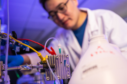 A decorative image of a researcher in a lab.