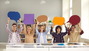 5 students holding up comment blurb above their head. 